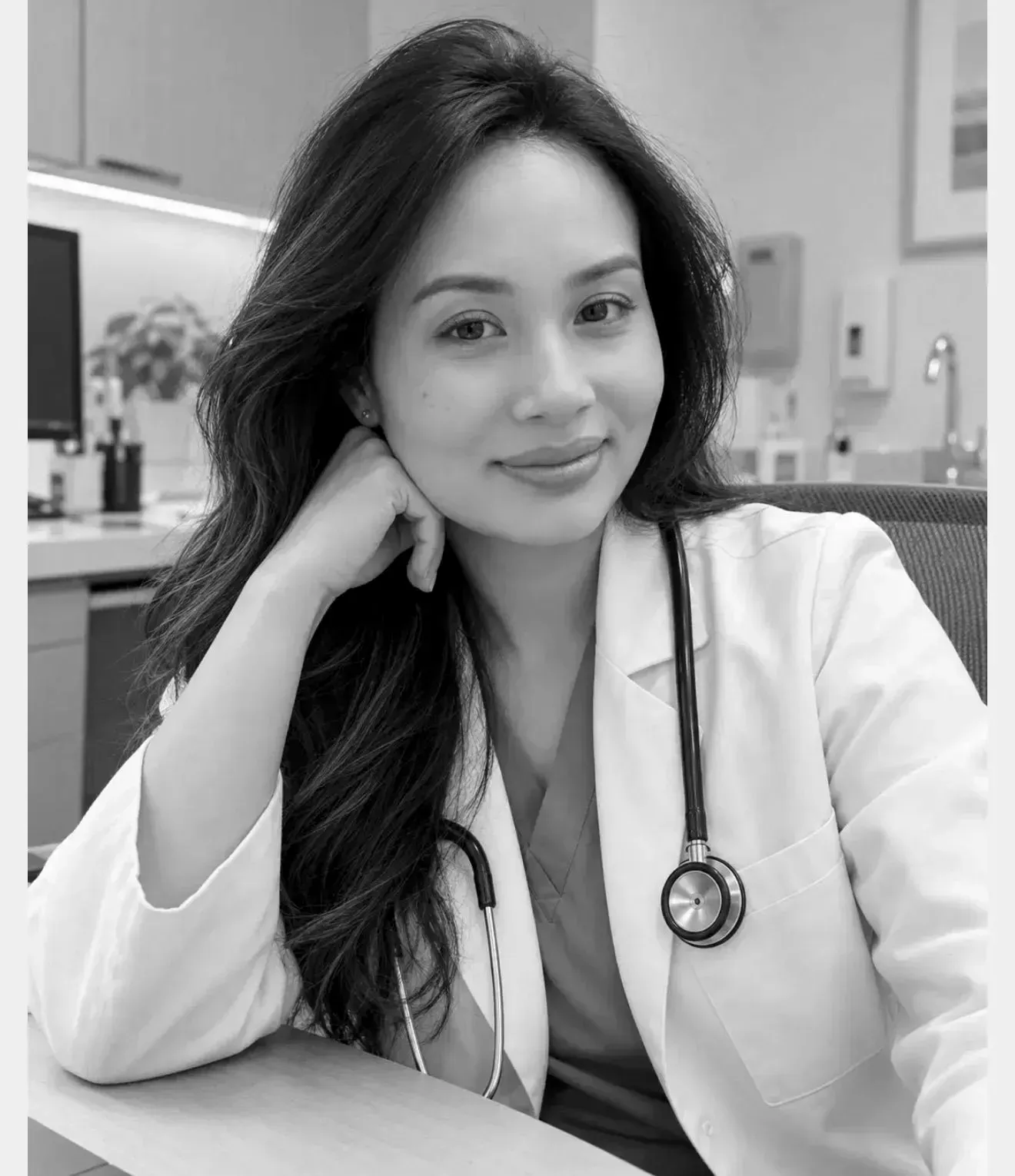 Dr. Mindy Le smiling in her white coat